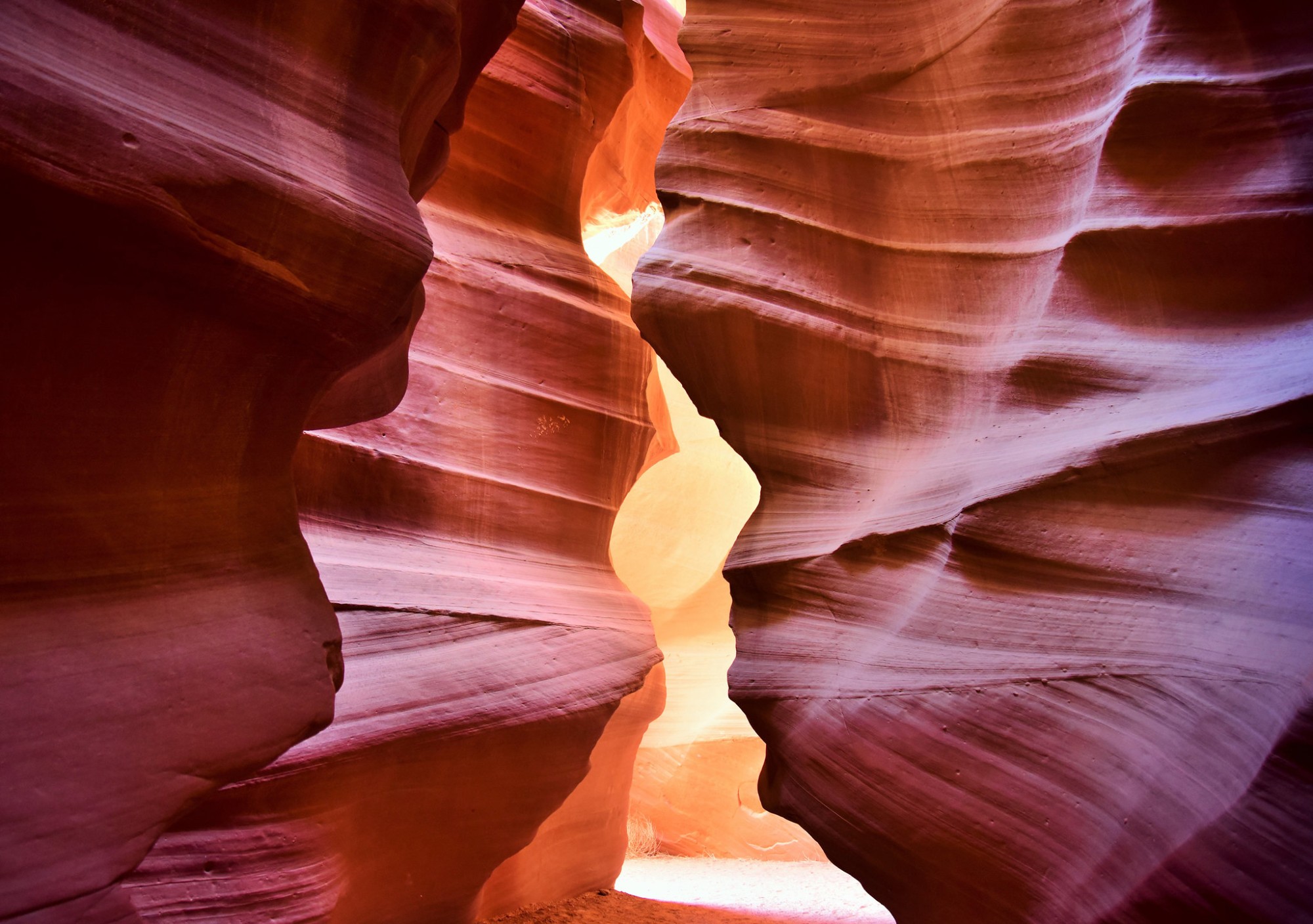 Antelope Canyon, a mesmerizing slot canyon in Arizona's Southwest, demonstrates nature's artistry. Carved from Navajo Sandstone over millennia, it draws global visitors to its stunning formations and play of light. Renowned for its beauty and rich history, it continues to captivate with its wave-like patterns and towering walls.