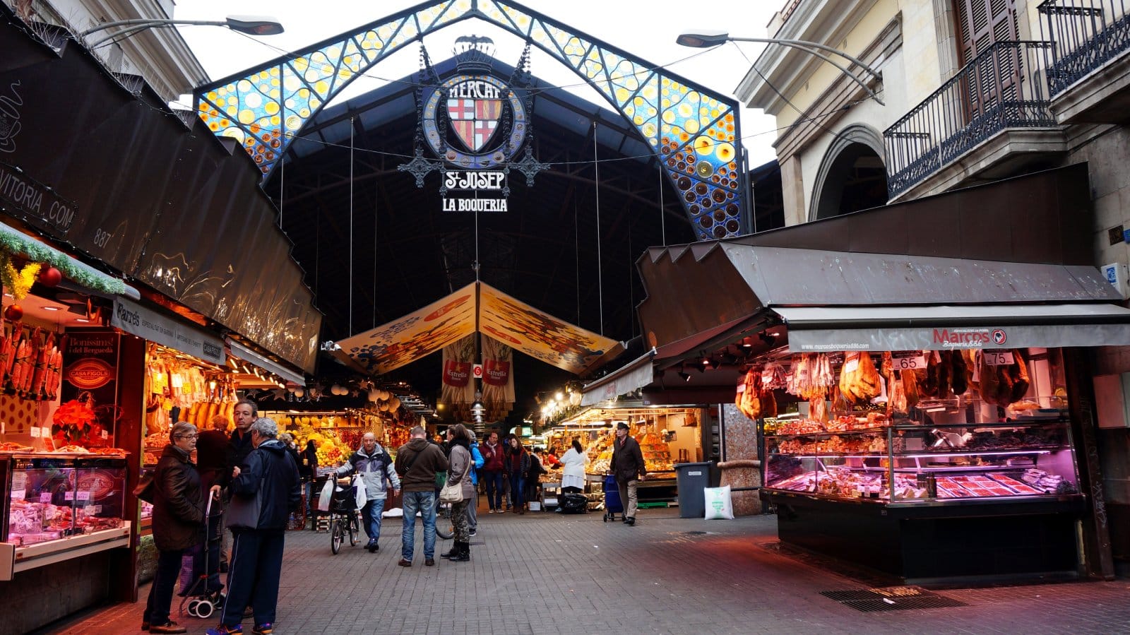 <p class="wp-caption-text">Image Credit: Shutterstock / Tang Yan Song</p>  <p><span>La Boqueria Market, officially known as Mercat de Sant Josep de la Boqueria, highlights Barcelona’s rich culinary heritage. Located along the bustling Las Ramblas, this market is a blend of colors, aromas, and flavors, offering an extensive array of local and exotic produce, meats, seafood, cheeses, and sweets. It’s a culinary exhibition showcasing the freshest ingredients that form the backbone of Catalan cuisine. Here, visitors can explore various stalls selling everything from Iberian ham to artisanal chocolates, making it a paradise for food lovers. The market also hosts several bars and eateries, where you can savor traditional dishes prepared with ingredients sourced directly from the market’s vendors.</span></p>