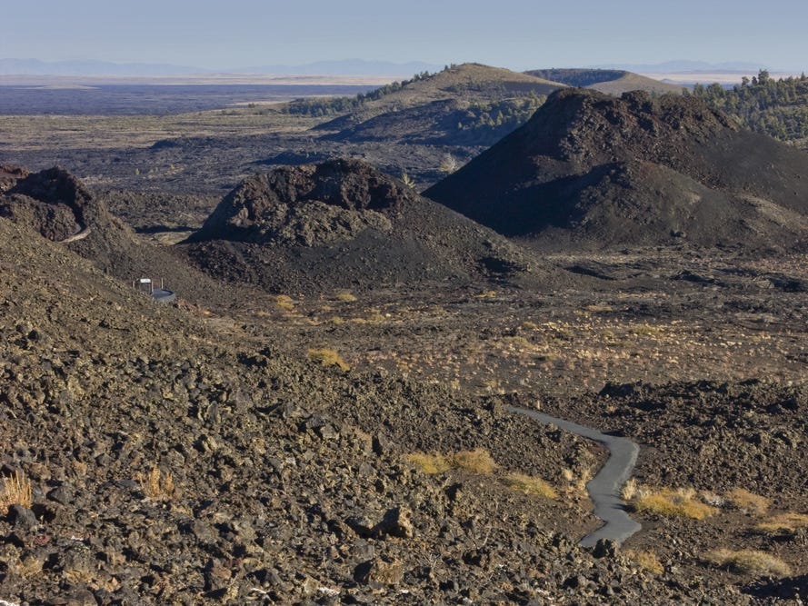 <p>Although Craters of the Moon is technically a national monument, it's part of the National Park System, so I'm including it on this list.</p><p>Located in Idaho, Craters of the Moon National Monument and Preserve is a favorite of mine that I think back on quite frequently.</p><p>The park is made up of dark-black volcanic rock called basalt, which gives it a unique look. Oftentimes, I'd hear folks mention that it reminded them of the landscape of a <a href="https://www.businessinsider.com/star-wars-filming-locations-you-can-visit-2019-5">"Star</a> <a href="https://www.businessinsider.com/star-wars-filming-locations-you-can-visit-2019-5">Wars" movie</a>.</p><p>With the acquisition of a free permit, visitors can explore inside caves called lava tubes. During my visit, I also had the opportunity to go on a ranger-led hike, which is an experience I highly recommend.</p>