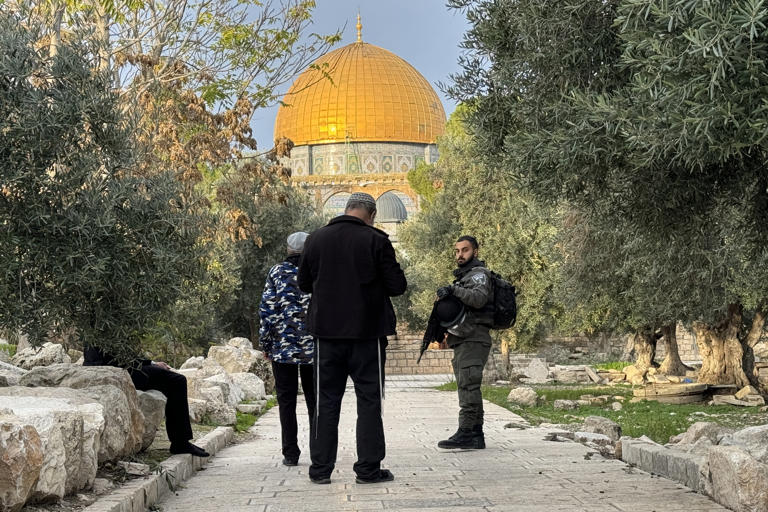 Jewish worshippers pray under police guard at the Temple Mount, which Muslims know as Al Haram Ash Sharif (The Noble Sanctuary). The holy site is one of the most contested on earth. Matthew Tostevin