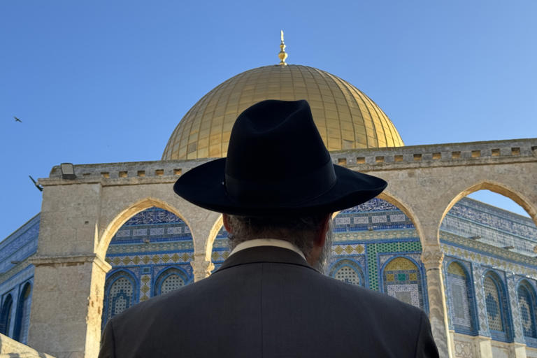 A religious Jew looks at the Dome of the Rock, an Islamic shrine in Jerusalem. Groups who believe in building a Third Temple say the Dome of the Rock stands on the exact spot where it must be built. Matthew Tostevin