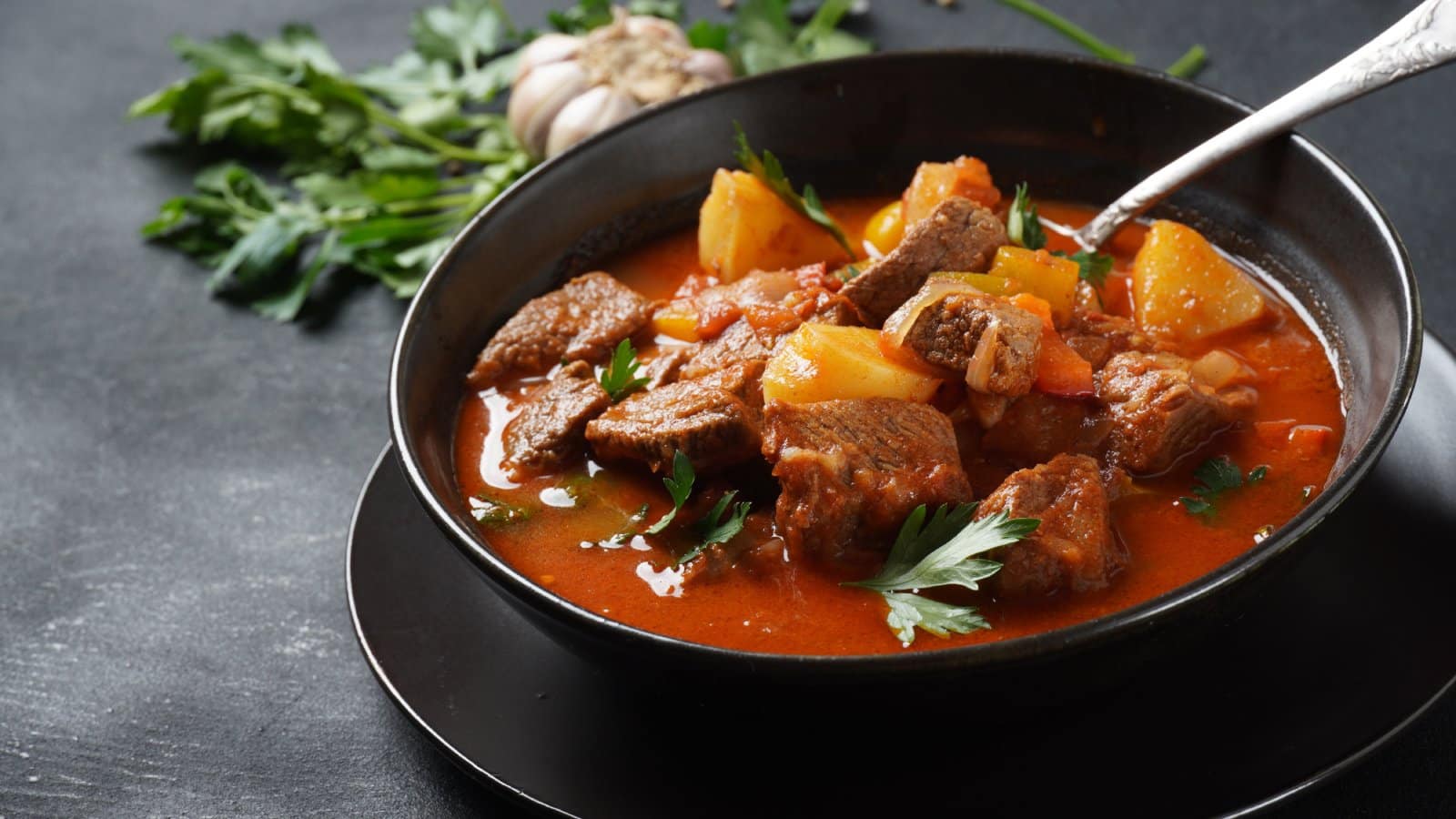 Image Credit: Shutterstock / Natalia Hanin <p>A warm, comforting stew of meat and vegetables, seasoned with paprika and other spices, embodying the heart of Hungarian cuisine.</p>