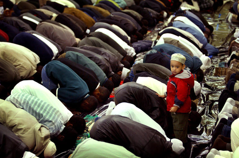 Two-year-old Abdalasis Sharid, 2, watches thousands of local Muslims, who are observing Eid Ul-Fitr with prayers at the Tennessee State Fairgrounds on Nov. 25, 2003. An estimated 5,000 marked the end of Ramadan.