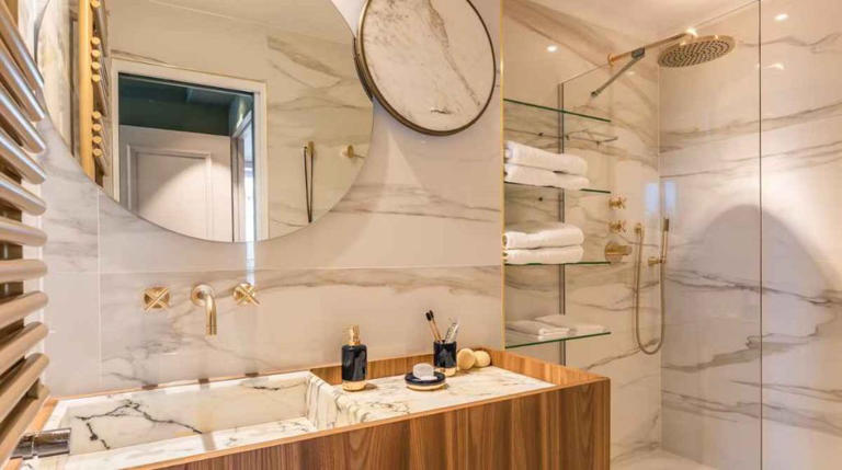 modern bathroom with gold and marble finishes