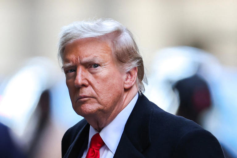 Former President Donald Trump arrives at 40 Wall Street after his court hearing to determine the date of his trial for allegedly covering up hush money payments linked to extramarital affairs in New York City on March 25, 2024.