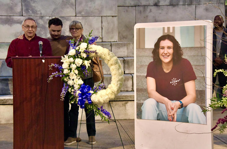 Pava LaPere's father, Frank LaPere, speaks about her at a vigil held in her memory, with her brother Nico and mother Caroline LaPere at his side.