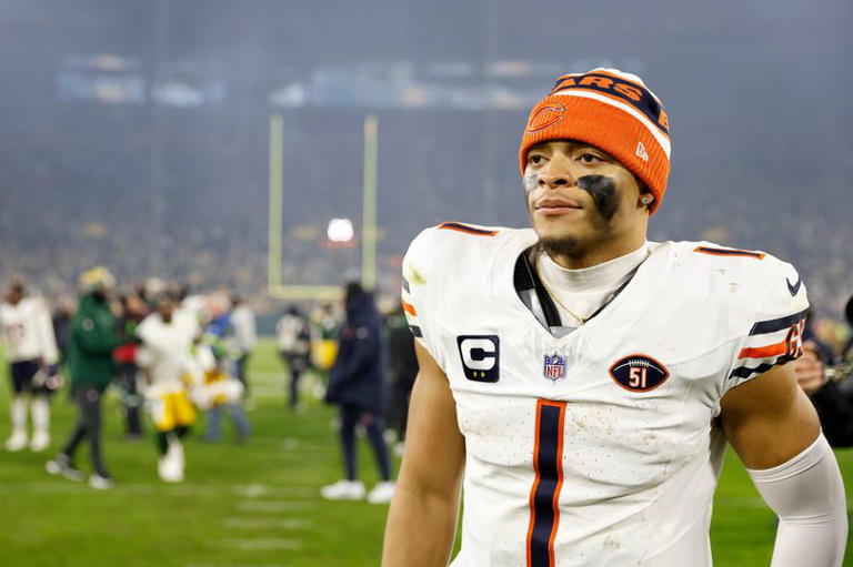 Justin Fields #1 of the Chicago Bears walks off the field after a loss to the Green Bay Packers at Lambeau Field on January 07, 2024 in Green Bay, Wisconsin