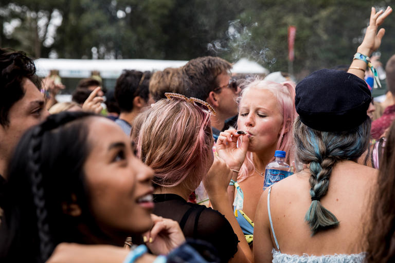 FILE: A fan smokes weed in the crowd during the Outside Lands Music Festival at Golden Gate Park in San Francisco on Saturday, Aug. 10, 2019. Several SF Live concerts are slated to take place at Golden Gate Park.
