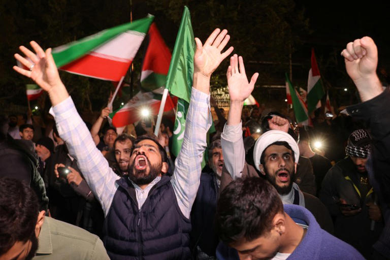 Iranian demonstrators react after the IRGC attack on Israel, during an anti-Israeli gathering in front of the British embassy in Tehran [West Asia News Agency via Reuters]
