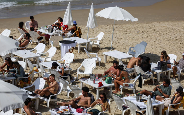 ‘We have to continue living’: Tel Aviv locals keep calm and carry on ...