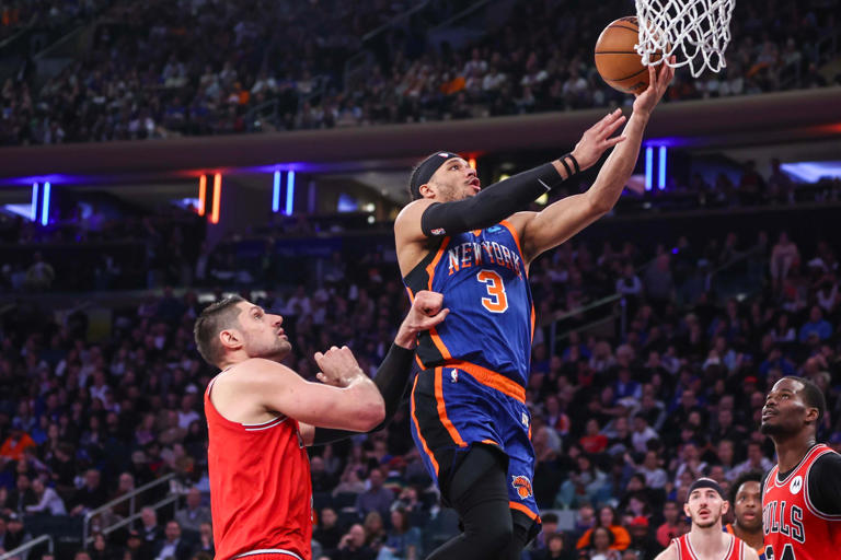 New York Knicks guard Josh Hart (3) drives past Chicago Bulls center Nikola Vucevic (9) for a layup during their game at Madison Square Garden on Sunday.
