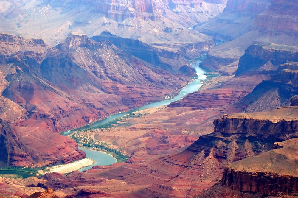 <p>The world is full of awe-inspiring <strong>natural wonders</strong> that attract millions of visitors annually. Here are some of the most breathtaking natural sights you should consider adding to your travel bucket list.</p><ol> <li><strong>Grand Canyon, USA</strong>: This magnificent gorge, carved by the Colorado River, stretches over 277 miles and reaches depths of over a mile. Its unique rock formations and panoramic vistas draw visitors from around the globe.</li> <li><strong><a href="https://travelswiththecrew.com/15-australian-landmarks-you-need-to-see/">Great Barrier Reef</a>, Australia</strong>: The world’s largest coral reef system, spanning over 1,400 miles, is home to diverse marine life. Visitors can snorkel, dive, or take a glass-bottom boat tour to experience the vibrant underwater world.</li> <li><strong>The Paricutin Volcano</strong>, a cinder cone volcano in Michoacán, Mexico, has captured global attention since its emergence in 1943. Remarkably, this geological feature surfaced in the cornfield of a local farmer named Dionisio Pulido, and it is the youngest volcano on the planet.</li> <li><strong>Aurora Borealis, The Arctic Circle</strong>: Also known as the Northern Lights, this celestial display of colorful, shimmering lights is caused by the interaction between solar particles and the Earth’s magnetic field. The best time to catch this phenomenon is during winter in high-latitude regions.</li> <li><strong>Mount Everest, Nepal</strong>: Standing at 29,032 feet, Mount Everest is Earth’s highest peak above sea level. While mountaineering enthusiasts dream of reaching the summit, trekkers can enjoy shorter hikes to Everest Base Camp to admire the mountain’s rugged beauty.</li> <li><strong>Victoria Falls, Zambia/Zimbabwe</strong>: One of the world’s largest and most famous waterfalls, Victoria Falls is over a mile wide and 354 feet high. Its powerful flow creates a dramatic mist, earning it the name “The Smoke That Thunders.”</li> <li><strong>Harbor of Rio de Janeiro</strong>: The world’s largest bay and most beautiful harbor is surrounded by spectacular rock formations, mountains, and the city of Rio.</li> </ol>