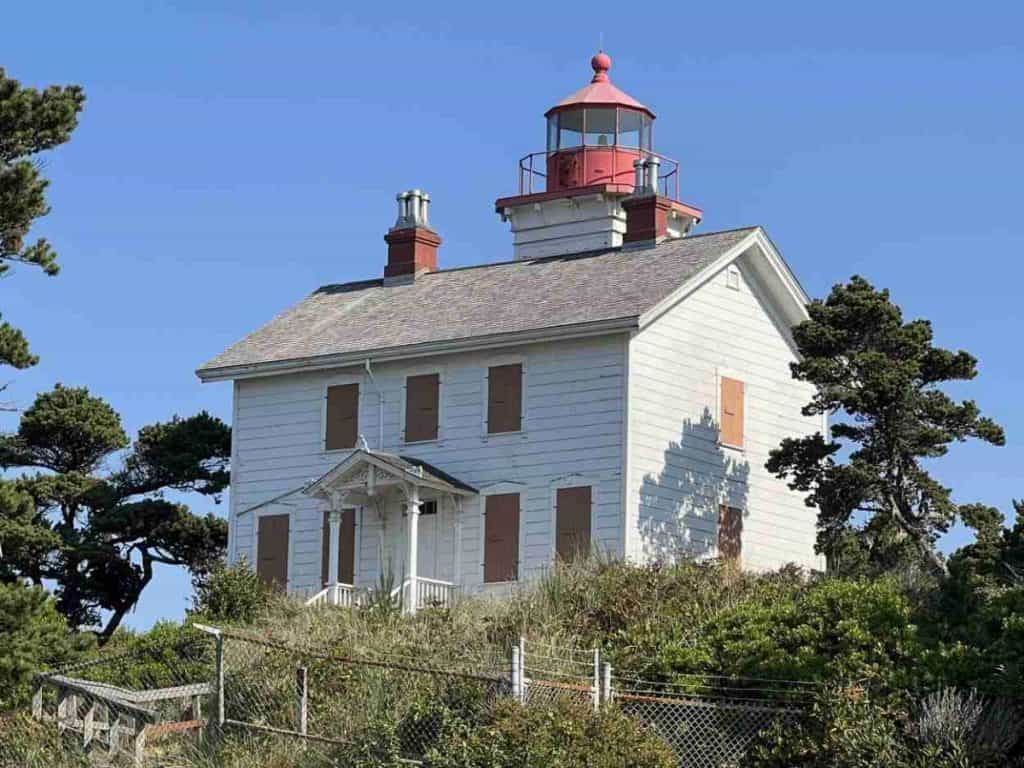 <p><strong>Year lit:</strong> 1871</p><p><strong>Height:</strong> 39.6 feet</p><p>Yaquina Bay Lighthouse sits a few miles south on the Oregon Coast Highway at MilePost 141.9. It is the only surviving state lighthouse with the light and living quarters in the same building and the state's only intact wooden beacon.</p><p>Yaquina Bay Lighthouse was re-lit in 1996 with a modern optic shining a steady white light from sunset to sunrise. Self-guided tours are free. In summer, the lighthouse is open daily from noon to 4 pm. Winter hours are noon to 4 pm, Wednesday through Sunday.</p>