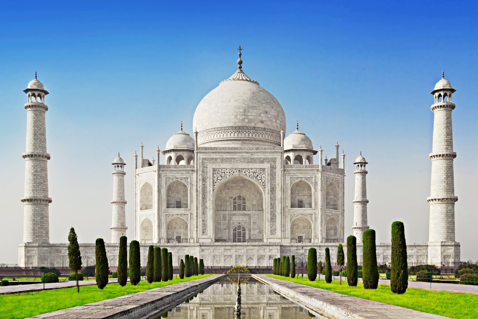<p>The <strong>Taj Mahal</strong> in Agra, India, was built by the Mughal emperor Shah Jahan in memory of his beloved wife.</p><p>Completed in 1653, this ivory-white marble mausoleum showcases intricate details, such as floral patterns and geometric shapes, that blend Persian, Islamic, and Indian architectural styles.</p><p>The Taj Mahal is best visited at sunrise or sunset, when the soft, golden light enhances its mesmerizing beauty.</p>