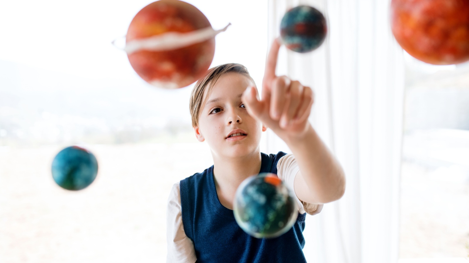 image credit: Ground Picture/Shutterstock <p>Build a scale model of the solar system using balls of different sizes and colors. Place them at appropriate distances to understand the vastness of space. This visual and tactile project reinforces the concept of scale and distance in the universe.</p>