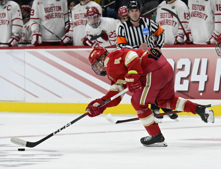 Denver Pioneers forward Jack Devine (4) skates the puck up ice during the first period of the 2024 NCAA Frozen Four semifinal game against the Boston University Terriers at the Xcel Energy Center in St. Paul, Minnesota on Thursday, April 11, 2024.