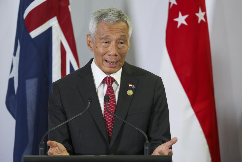 singapore prime minister lee to step down, hand power to his deputy