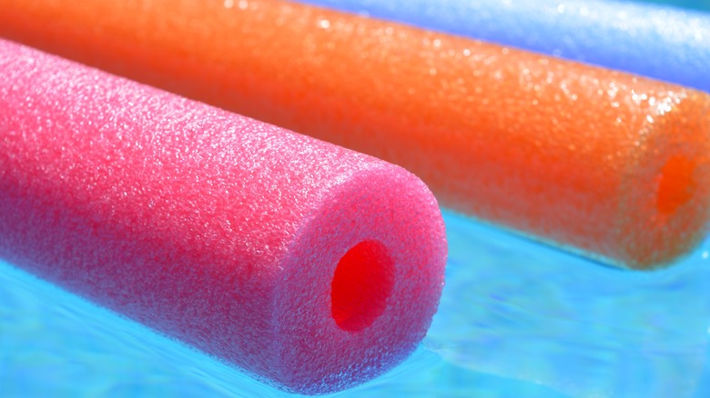 the pool noodle hack that makes spray painting cabinet doors a breeze