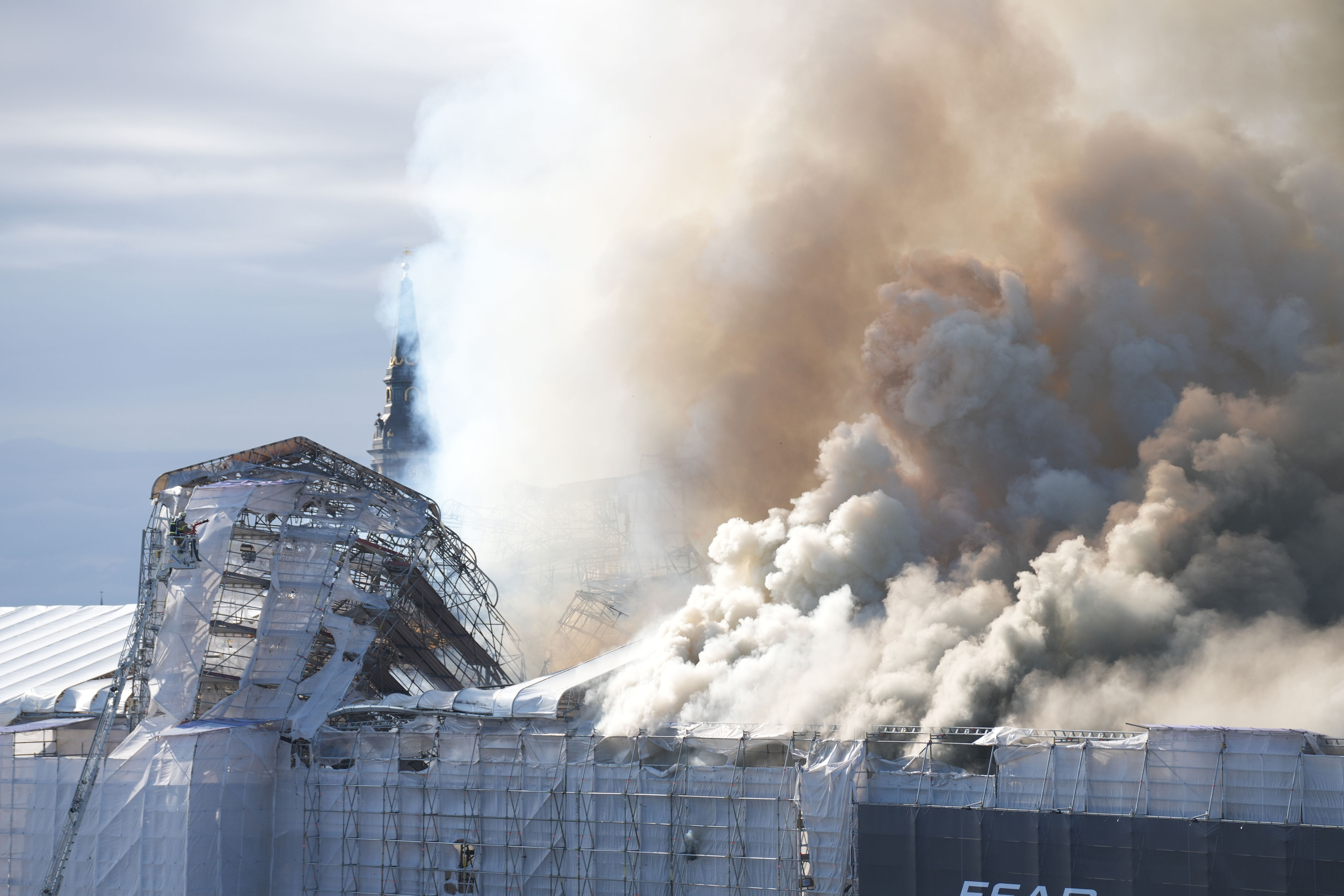 fire rages through the 17th-century old stock exchange in copenhagen and its spire has collapsed