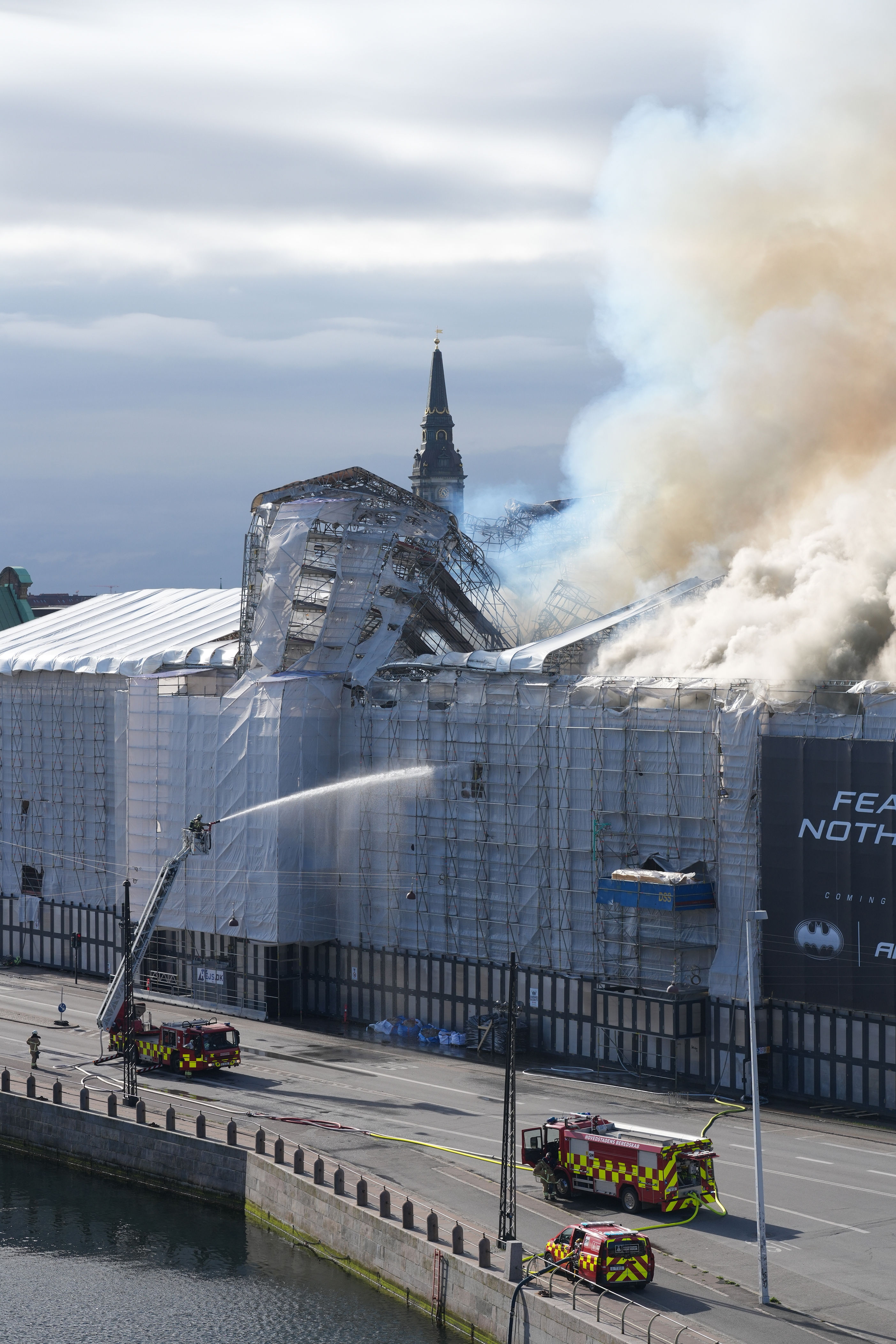 fire rages through the 17th-century old stock exchange in copenhagen and its spire has collapsed