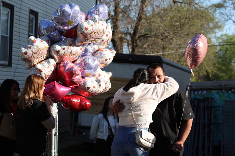 Jose Molina, right, is consoled before the start of a prayer vigil for his slain daughter Ariana Molina in the 2000 block of West 52nd Street in Chicago on Monday, April 15, 2024. A shooting over the weekend claimed the life of 9-year-old Ariana Molina.