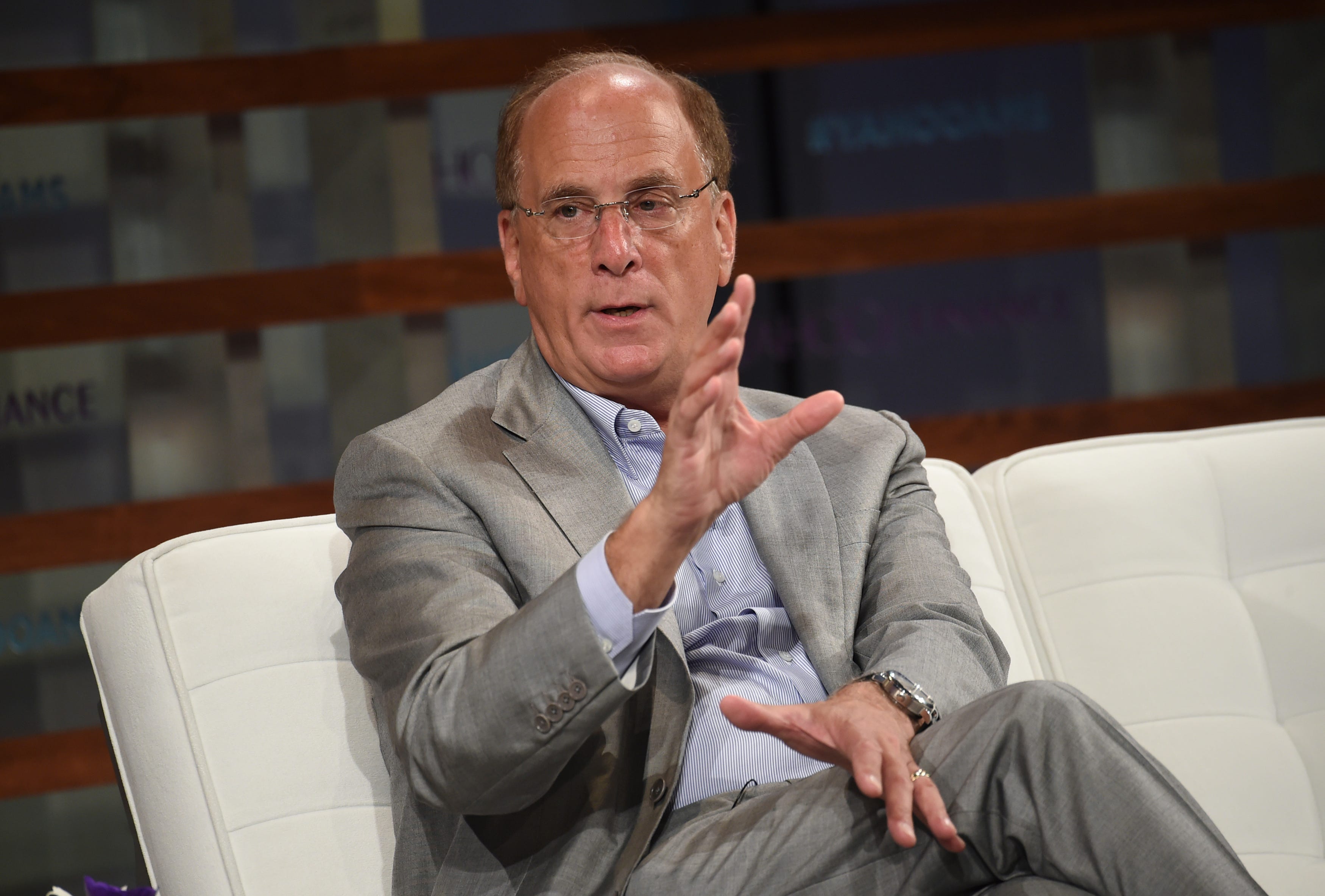 microsoft, blackrock's larry fink thinks ai will boost wages — and productivity