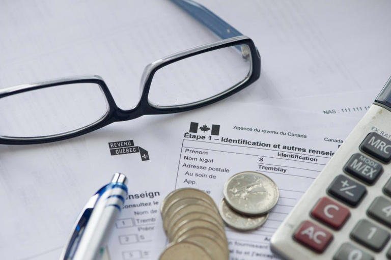 Close up photograph of the Canada Revenue Agency (CRA, Agence du revenu du Canada ARC in french) and Revenu Quebec individual income tax return form on white background in Gatineau, Quebec, Febuary 10, 2019.