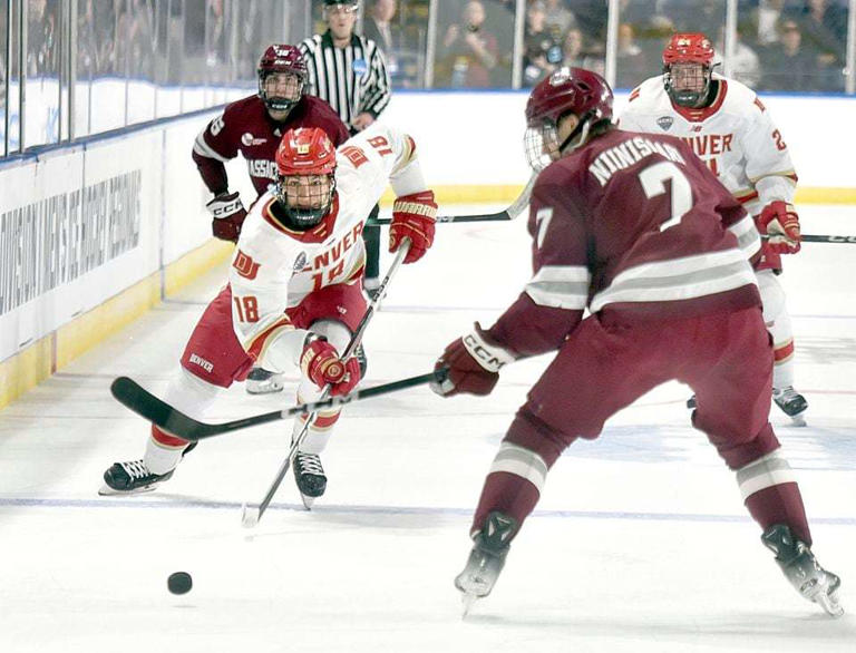 Denver's Jared Wright races for the puck as UMass' Samuli Niinisaari defends during first period action in the NCAA division one hockey tournament at the MassMutual Center in downtown Springfield.  (Don Treeger / The Republican) 3/28/2024