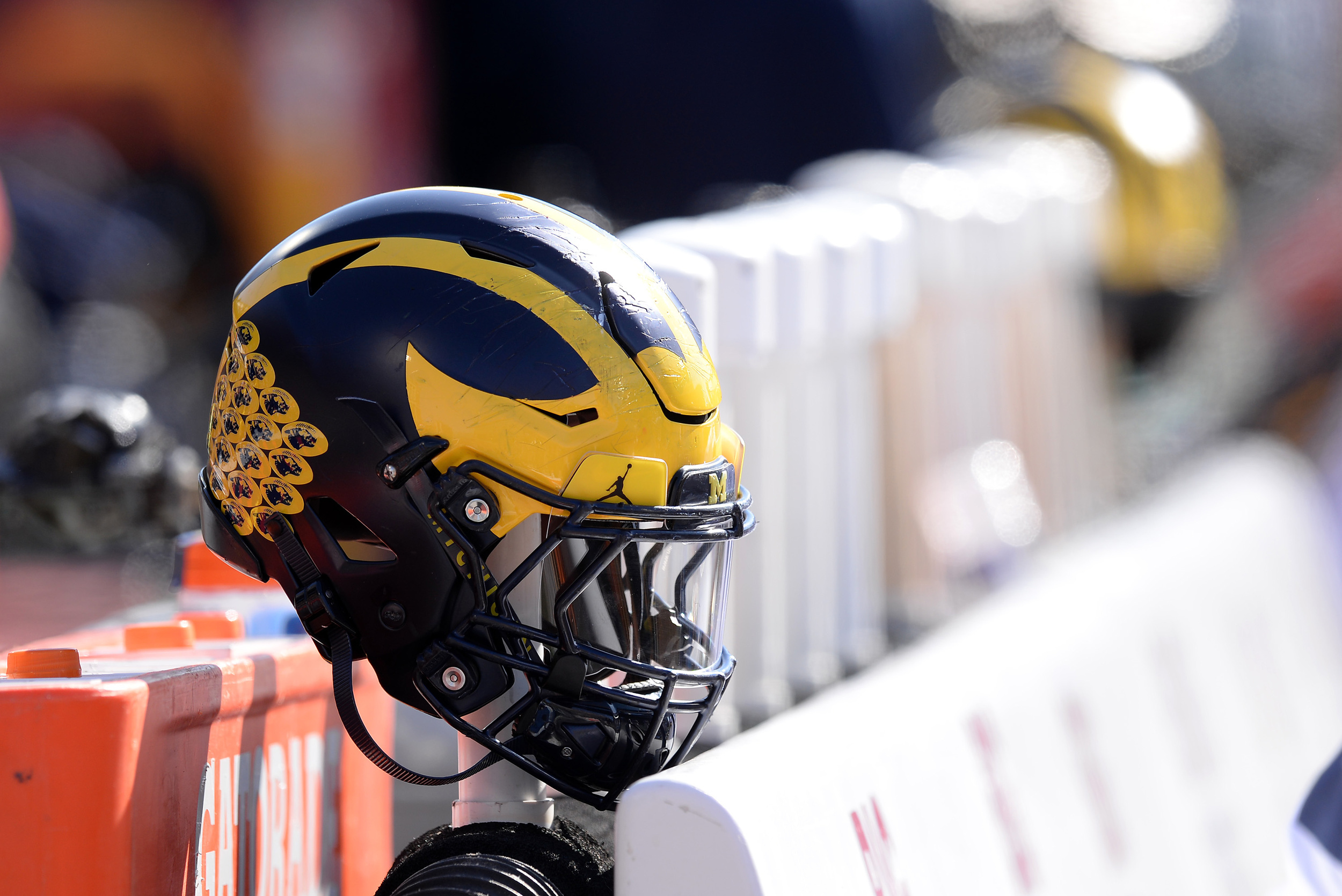 michigan wolverines punished by ncaa for violations