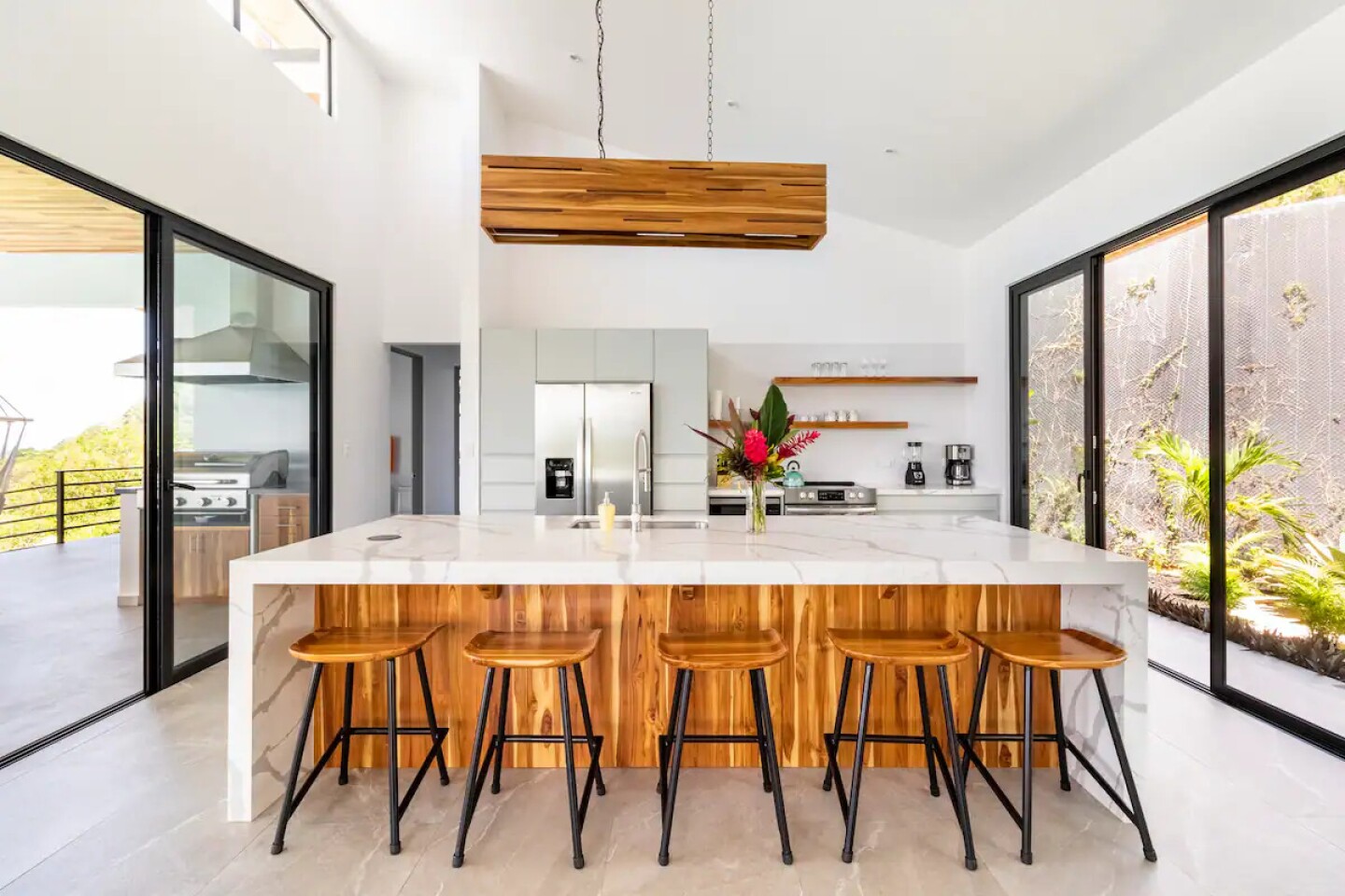 <a>The kitchen is a stylish gathering space in this minimalist design home.</a>