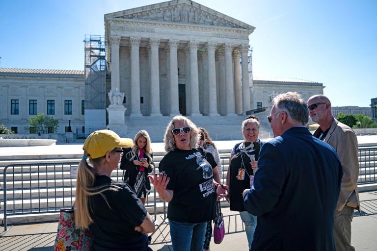 Supporters of January 6 defendants, including Micki Witthoeft, the mother of Ashli Babbitt, who was killed during the Capitol attack on Jan. 6, 2021, gather Tuesday outside of the Supreme Court.