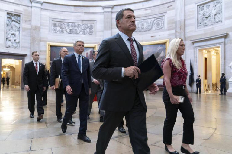 Republican House impeachment managers carry articles of impeachment against Homeland Security Secretary Alejandro N. Mayorkas to the Senate on Tuesday. ((Jose Luis Magana / Associated Press))