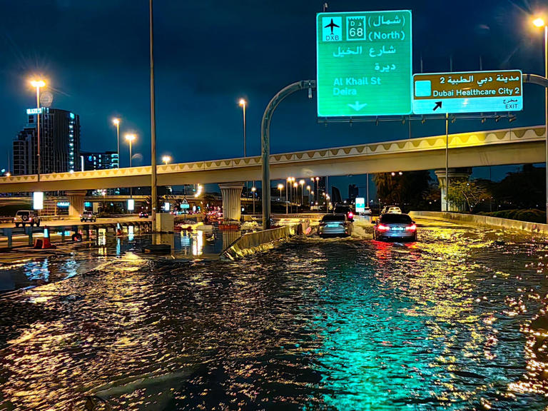 Cars are engulfed in water on a busy road in Dubai. GIUSEPPE CACACE/Getty Images