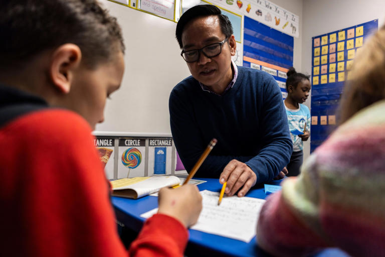 Special education teacher Eugene Calingacion helps third grader Sajjad Alsaidi practice writing Thursday, March 21, 2024, at Jones-Farrar International Baccalaureate World School in Freeport.