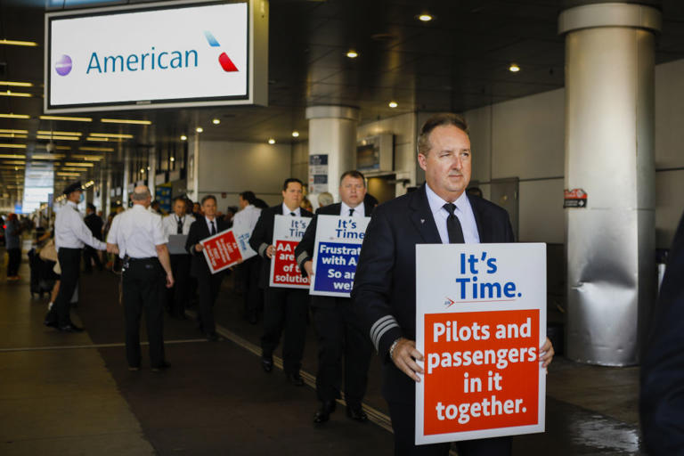 Pilots of American Airlines picket outside Miami International Airport in Miami, Florida, U.S., on March 23, 2022.