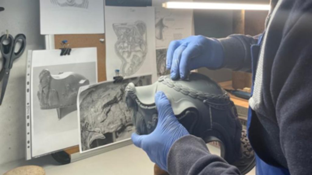 <p>Two new additions have recently been added to the Hallaton Helmet display at Harborough Museum. Two replicas of the helmet have been made that give museum visitors an idea of what the helmet may have looked like when it was worn by a Roman officer.</p><p>The first replica was created by a Leicestershire-based silversmith named Rajesh Gogna. Using scans of the helmet, Gogna was able to 3D-print a resin model of the helmet that he then decorated with silver and gold.</p>