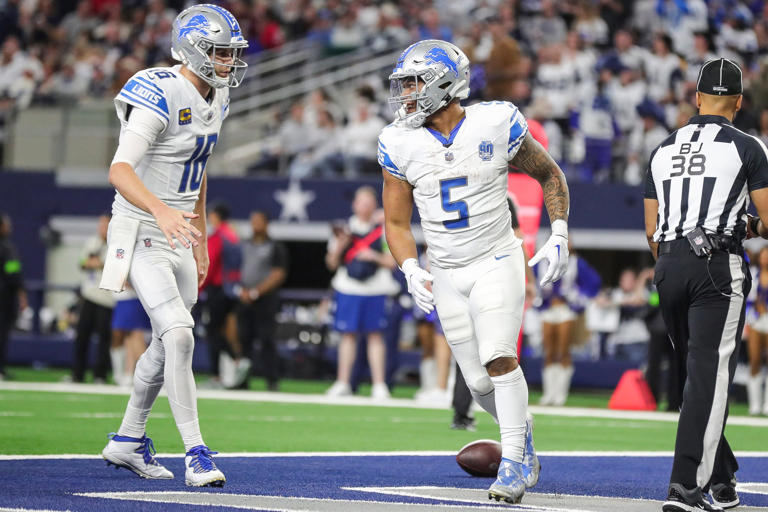 Lions running back David Montgomery celebrates a touchdown against the Cowboys with quarterback Jared Goff during the second half of the Lions' 20-19 loss at AT&T Stadium in Arlington, Texas on Saturday, Dec. 30, 2023.