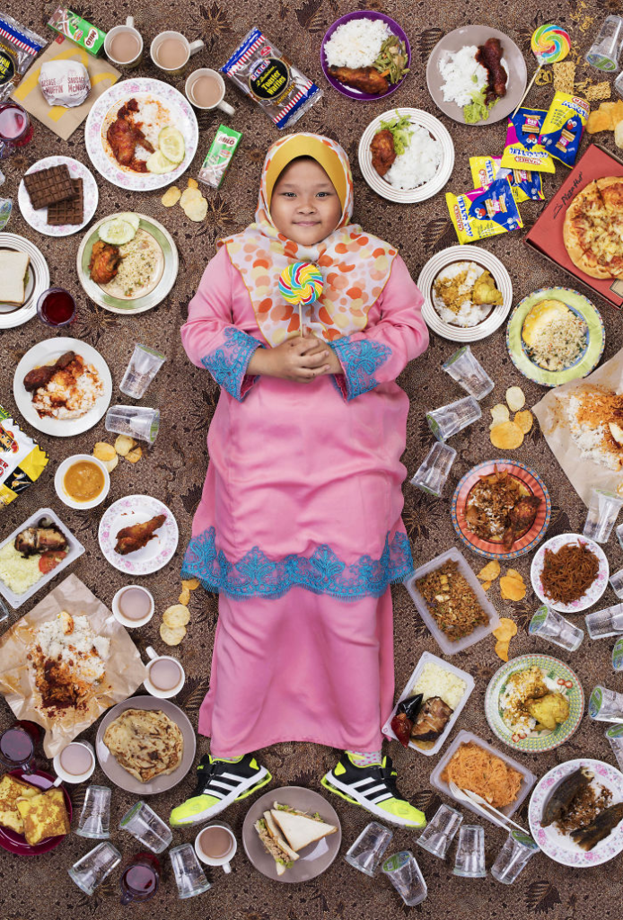 <p>This picture was taken on March 26, 2017, of Siti Khaliesah Nataliea Muhamad Khairizal, 9, of Kuala Lumpur, Malaysia. In an area outside of Kuala Lumpur, Siti lives with her father, who sells cars, her mother, who stays at home, and her four brothers. Mum cooks and sets the rules for the table: say the Du’a, don’t drink water before meals, and don’t talk during meals. But because everyone is so busy, the family doesn’t usually sit down to dinner together. Siti loves spaghetti carbonara and the smell of fried instant noodles so much. Her school is in China, where she learns Mandarin, plays the Melodian, and does Taekwondo. Siti wants her dad to put money under her pillow every night before she goes to sleep. She gathers different kinds of coins and money from other countries. Siti is going to buy an iPad when she has enough money.</p>