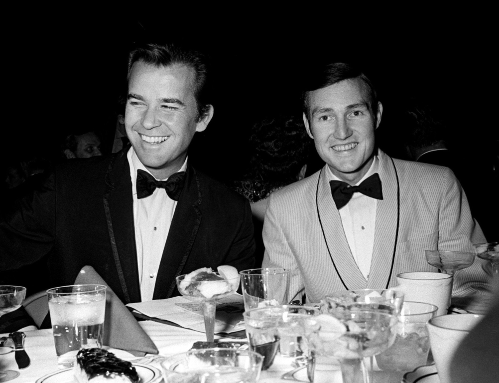 Dick Clark, left, master of ceremonies, and Don Light, president of Nashville chapter of NARAS, break bread together before the Grammy ceremonies got under way at the National Guard Armory in Nashville March 12, 1969.  69 Grammy 06