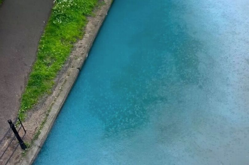 river cam runs bright blue and baffles onlookers as environment inspectors mount probe