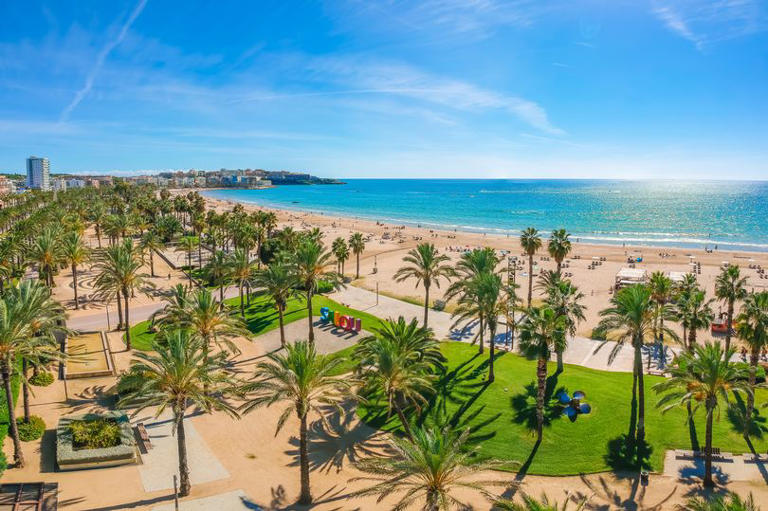 Beach, blue sea and palm trees in Salou city, Catalonia, Spain