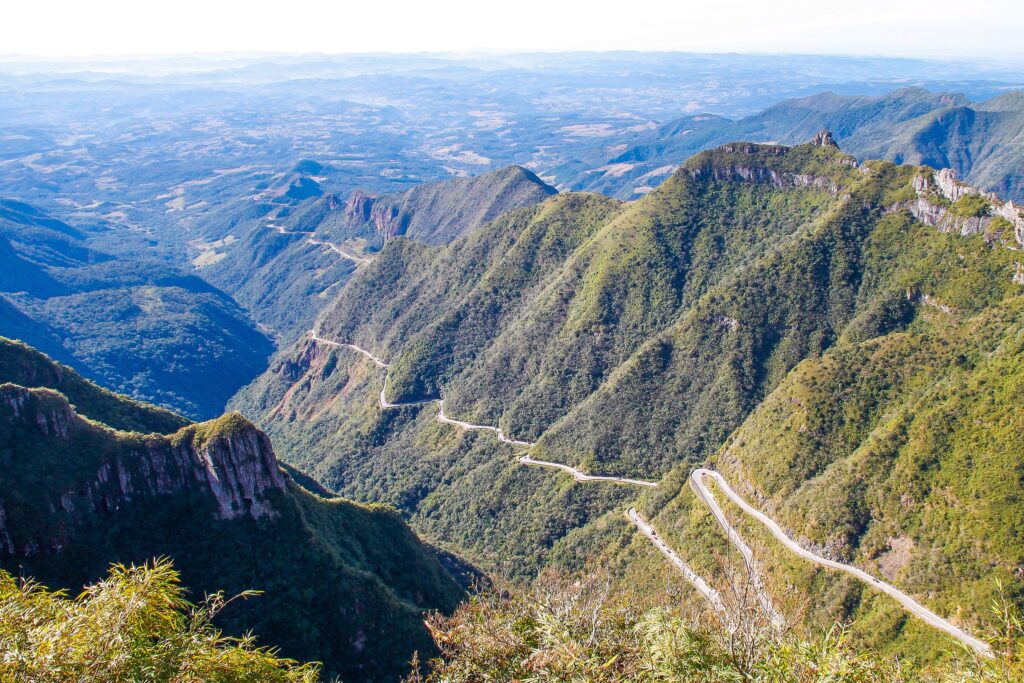 <p>This Brazilian mountain road is famous for its extreme curves and breathtaking views. The road climbs the Santa Catarina range with more than 250 turns along 12 kilometers, often enveloped in thick fog, adding to its mystique and challenge. The summit provides panoramic views of the Atlantic Forest, making it a photographerâs and riderâs paradise. Due to occasional heavy fog and rainfall, riders are advised to tackle this route with caution.</p>