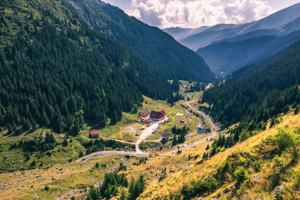<p>Romania’s Transfagarasan Highway, also known as Ceausescu’s Folly, is touted as one of the most scenic roads in the world. Crossing the Fagaras mountain range in the Transylvanian Alps, the road covers over 90 kilometers of twists, turns, steep descents, and tunnels. Its most iconic point is the view of Lake Balea from the highest point of the road. This route was famously featured on BBC’s Top Gear, where it was dubbed “the best road in the world.”</p>