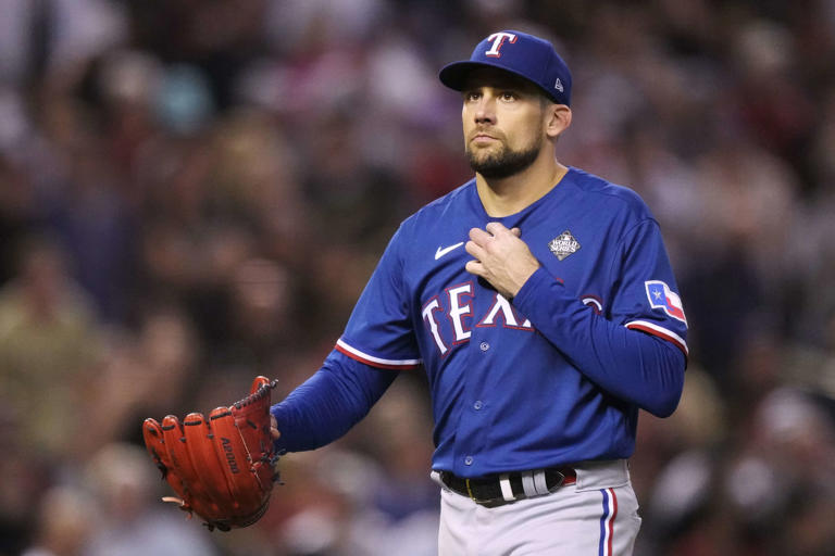Texas Rangers starting pitcher Nathan Eovaldi heads back to the dug out after getting out of a two runners on, 1 out jam, during the third inning in Game 5 of the World Series against the Arizona Diamondbacks, Wednesday, Nov. 1, 2023, in Phoenix.