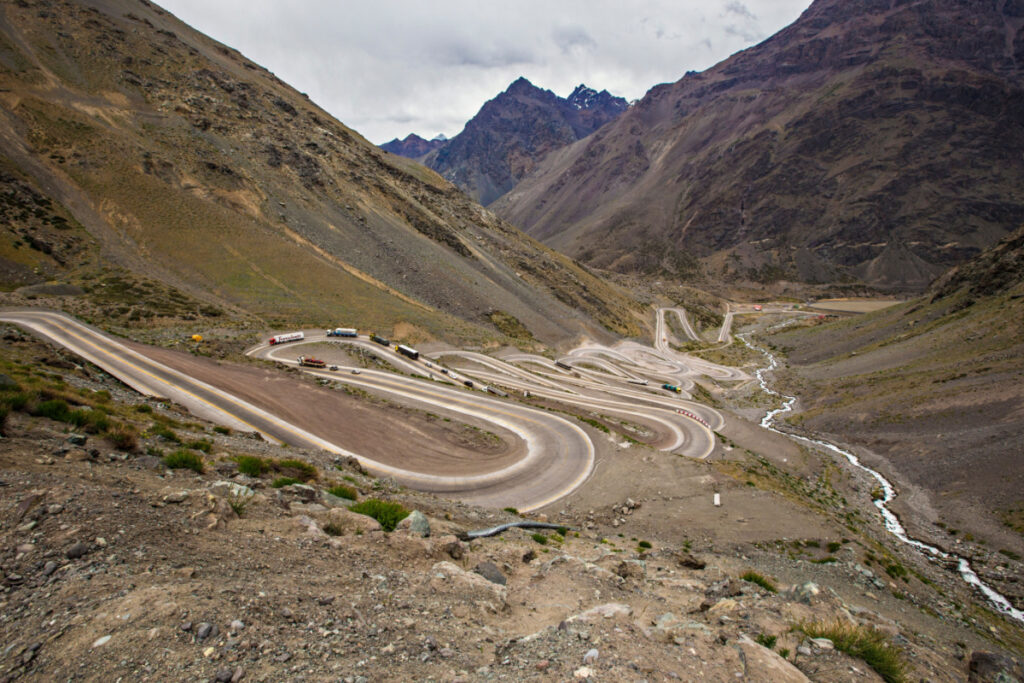 <p>The Paso de los Caracoles, or Snails Pass, also known as Paso Internacional Los Libertadores, is a mountain pass in the Andes between Argentina and Chile. It’s known for its series of 29 hairpin turns on the Chilean side, which offers an incredible riding experience for motorcyclists. The route provides stunning views of Aconcagua, the highest mountain in the Americas. Snow can close the pass during winter, so summer is the best time to ride.</p>