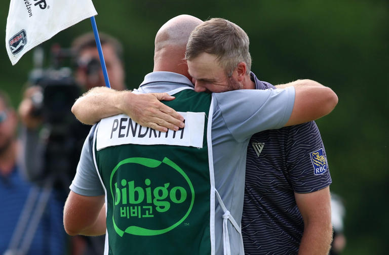 Taylor Pendrith hugs his caddie Mitchell Theoret after putting in to win on the 18th green during the final round of THE CJ CUP Byron Nelson at TPC Craig Ranch on May 05, 2024 in McKinney, Texas. (Photo by Tim Heitman/Getty Images)