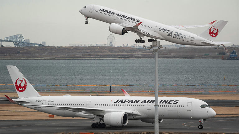 A passenger jet from Japanese carrier Japan Airlines (JAL) takes off past another at Tokyo International Airport at Haneda on February 2, 2023. Getty Images