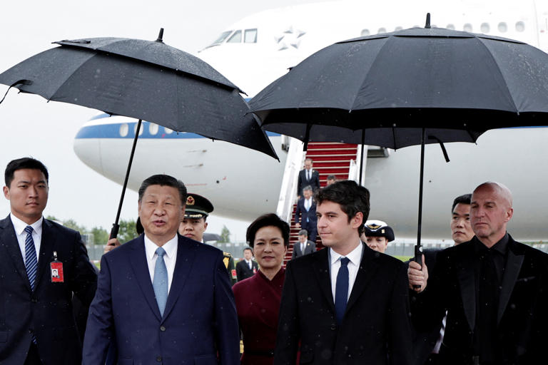 China's President Xi Jinping and his wife Peng Liyuan were greeted by France's Prime Minister Gabriel Attal at Orly airport on Sunday [Stephane de Sakutin/Pool via Reuters]
