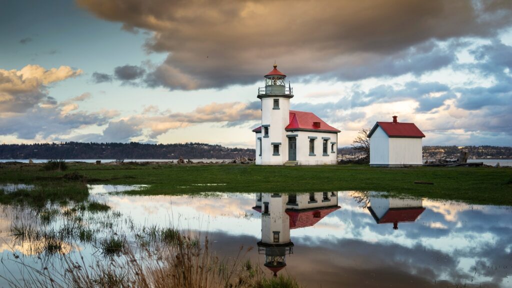 <p>Standing on the idyllic<a href="https://roamthenorthwest.com/13-unforgettable-towns-you-can-only-reach-by-air-or-sea/"> Vashon Island</a> since 1885, the Point Robinson Lighthouse is a near identical twin to the Alki Point Lighthouse located just to the Northeast. This lighthouse has a long history as an active navigational aid and the light keepers quarters were staffed until the late 1980s!</p><p>Today the lighthouse stands within Point Robinson park where locals and visitors can enjoy access to the water, peek around the lighthouse, and even stay in one of the two restored keeper’s cottages.</p>