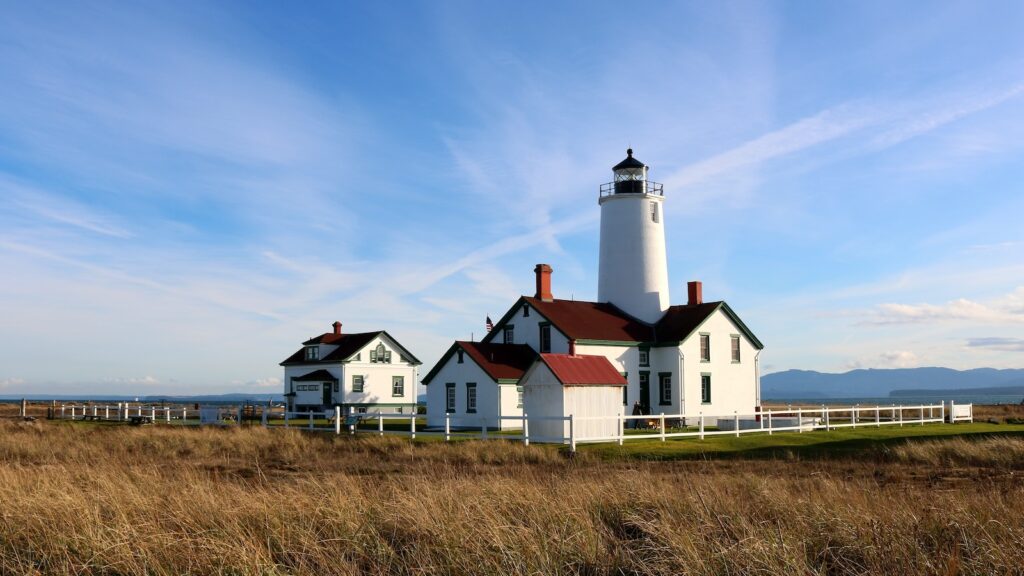 <p>Standing as the second oldest lighthouse in Washington, the New Dungeness Lighthouse has been in continuous operation watching over the waters of the Strait of Juan de Fuca since 1857. Originally the lighthouse stood at 100 feet tall but structural issues resulted in it being lowered to its current height of 63 feet.</p><p>The lighthouse is located at the end of the Dungeness Spit which juts 5 miles out into the Strait. Members of the New Dungeness Light Station Association staff the lighthouse 24/7 and run tours every day of the week.</p>
